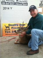 Man holding killed buck