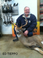Man holding killed buck