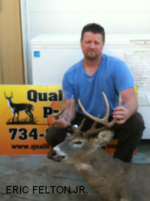 Man holding killed buck