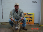 Man holding killed buck