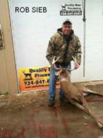 Man holding killed buck