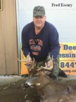 Man holding killed buck