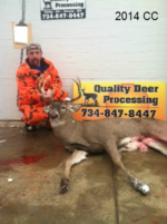 Man holding killed buck