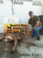 Man holding killed buck