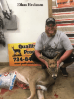 Man holding killed buck