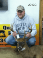 Man holding killed buck