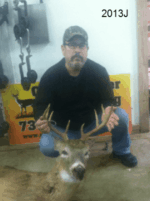 Man holding killed buck