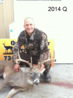 Man holding killed buck