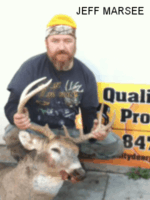Man holding killed buck