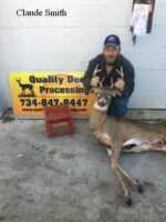 Man holding killed buck