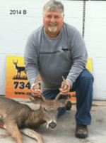 Man holding killed buck