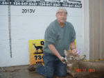 Man holding killed buck