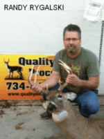 Man holding killed buck