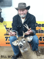 Man holding killed buck