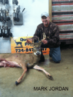 Man holding killed buck