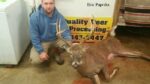 Man holding killed buck