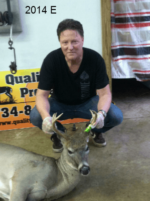 Man holding killed buck