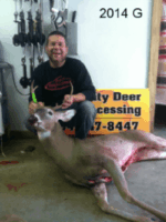 Man holding killed buck