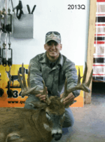 Man holding killed buck