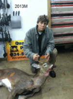 Man holding killed buck