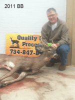 Man holding killed buck