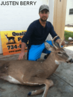 Man holding killed buck