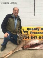 Man holding killed buck