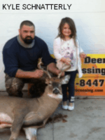 Man and girl holding killed buck