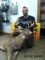 Man holding killed buck