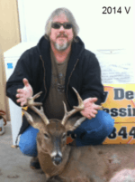 Man holding killed buck