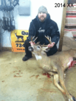 Man holding killed buck