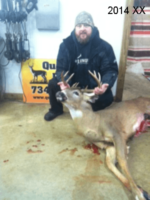 Man holding killed buck