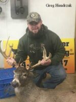 Man holding killed buck