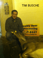 Man holding killed buck