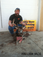 Man holding killed buck