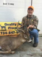 Man holding killed buck