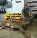 Man holding killed buck