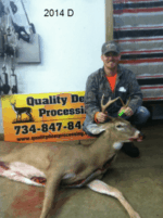 Man holding killed buck