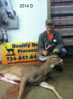 Man holding killed buck