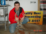 Man holding killed buck