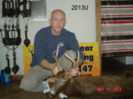 Man holding killed buck