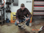 Man holding killed buck